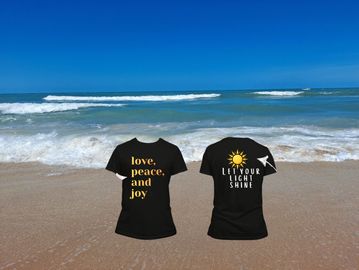 Black t-shirts with positive messages on a beach background.