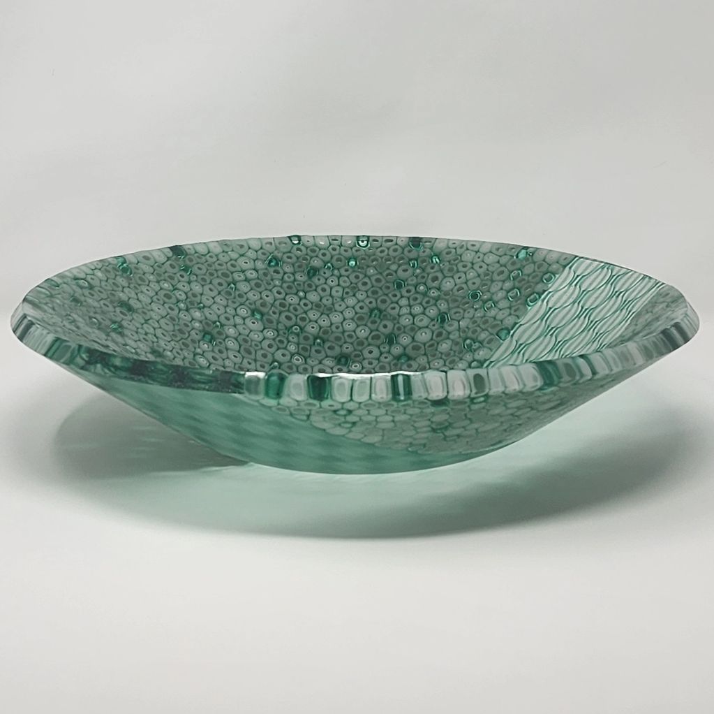 Decorative green glass bowl with a textured pattern.