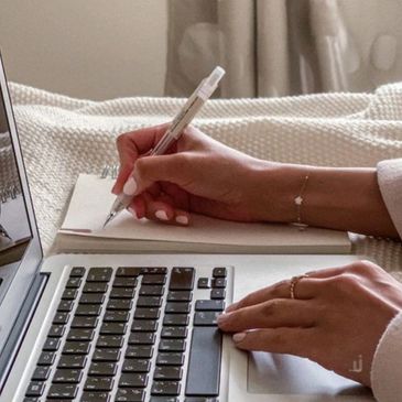 A photo of someone writing in a journal