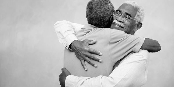 A picture of two men hugging.