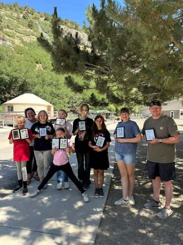 students displaying watercolor painting