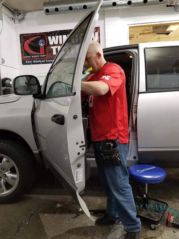 David Owens, the owner of Diamond's Edge Automotive Accessories in Omaha Nebraska, is installing tin