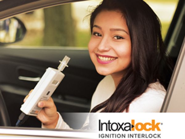 female person smiling after getting Intoxalock Interlock start device installed in her vehicle by Di
