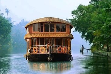 Traditional houseboat sailing on calm water.