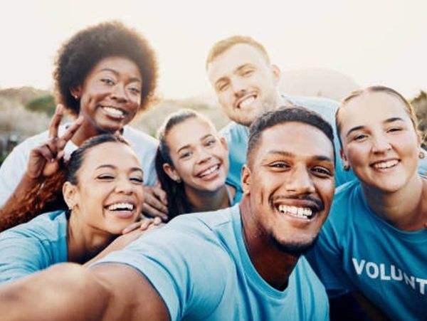 Group of young volunteers taking a cheerful selfie.