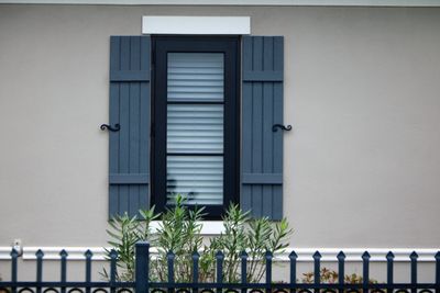 Gray mahogany faux wood shutters with decorative hardware