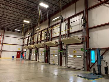 A clean warehouse loading dock with several closed overhead doors numbered 5 to 9.