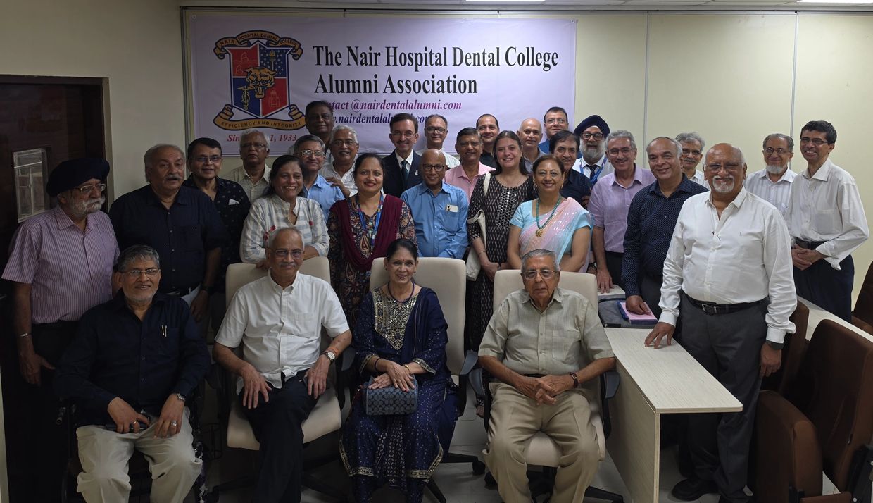 Group photo of dental college alumni at a reunion event.