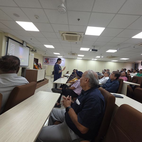 A speaker addresses an attentive audience in a conference room.