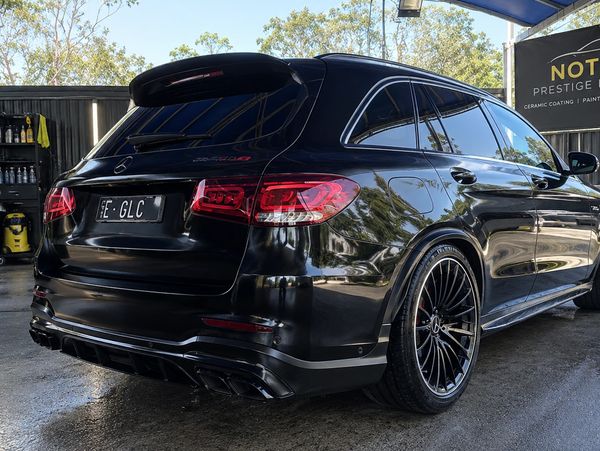 Rear view of a black Mercedes-Benz SUV with tinted windows.