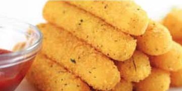 Close-up of crispy mozzarella sticks with marinara sauce.