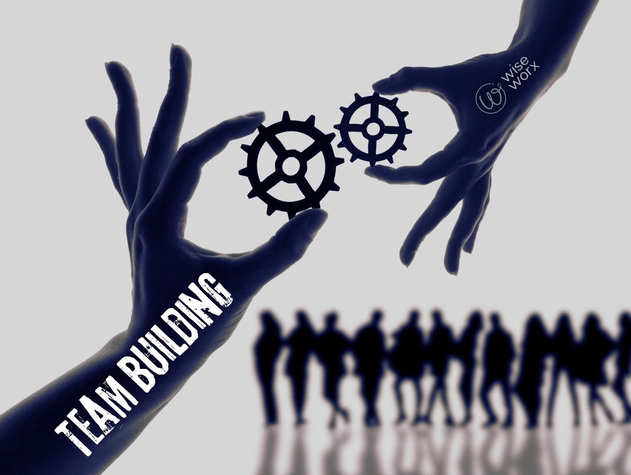 Hands holding gears symbolizing team building.