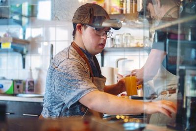 Image of a man working at a cafe