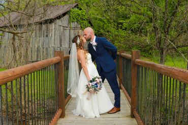 Bride and Groom on bridge with scenic mountain background
