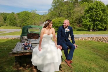 Bride and Groom relaxing on flatbed truck.