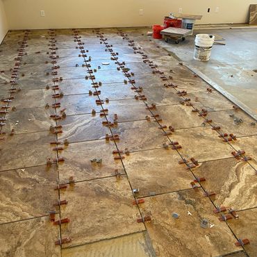 Floor installation with leveling clip spacer