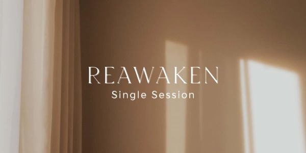 Text reading 'REAWAKEN Single Session' on a beige background with light shadows.