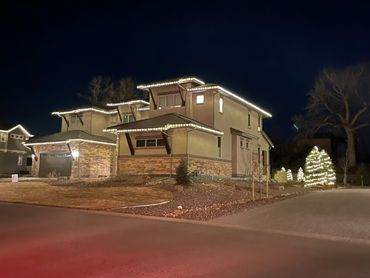 House decorated with Christmas lights at night.