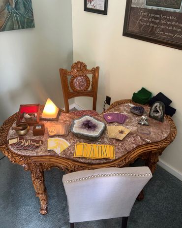 Psychic and tarot card reading table with an amethyst geode.