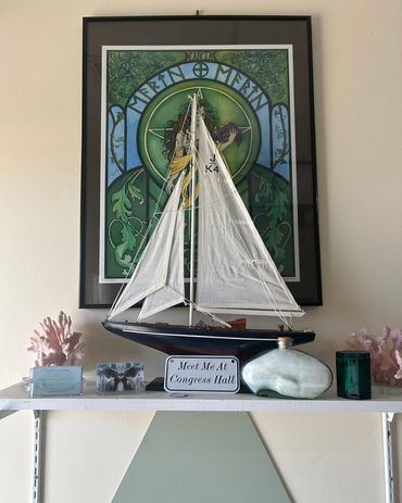 A sailboat replica with "Meet Me At Congress Hall" written in front.