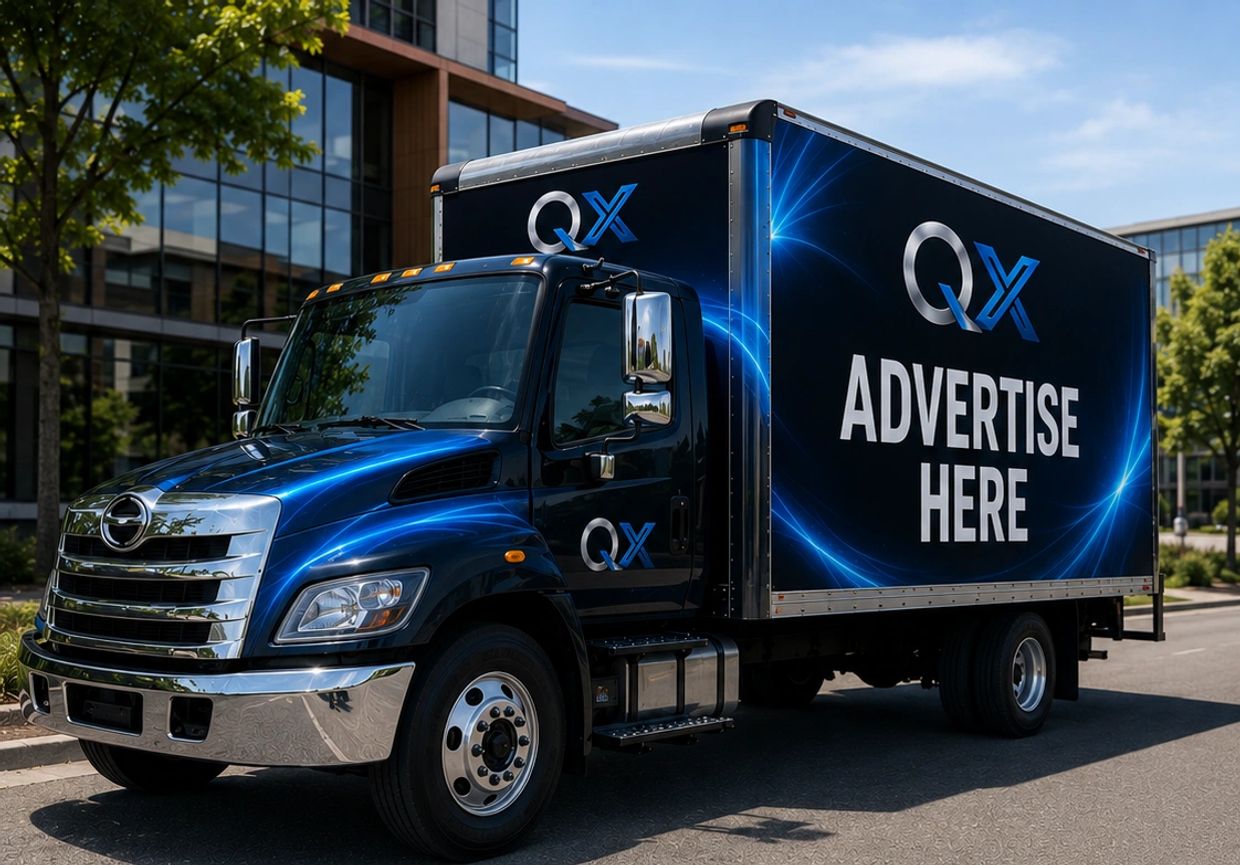 Blue advertising truck parked on city street.