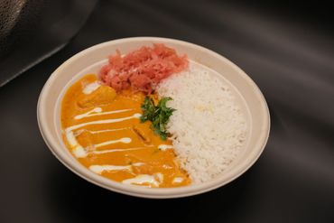 Creamy and rich Halal Butter Chicken Curry paired with fluffy rice in Covent Garden London.
