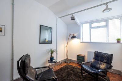 Cozy corner with two black chairs and a floor lamp.