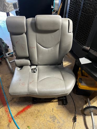 Gray leather car seat with markings and measurements.