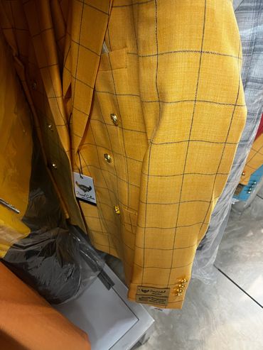 Yellow checkered blazer with gold buttons.