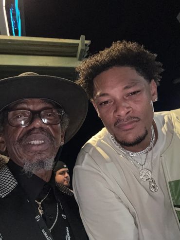 Two men posing for a nighttime selfie.