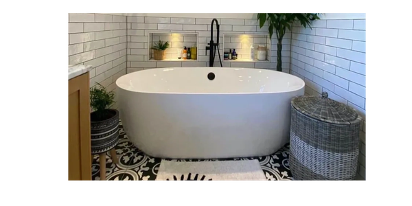 Modern white bathtub with patterned floor tiles in a stylish bathroom.