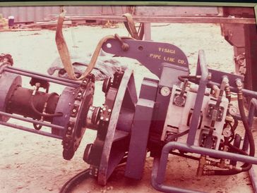 Industrial pipeline welding machine on a construction site.