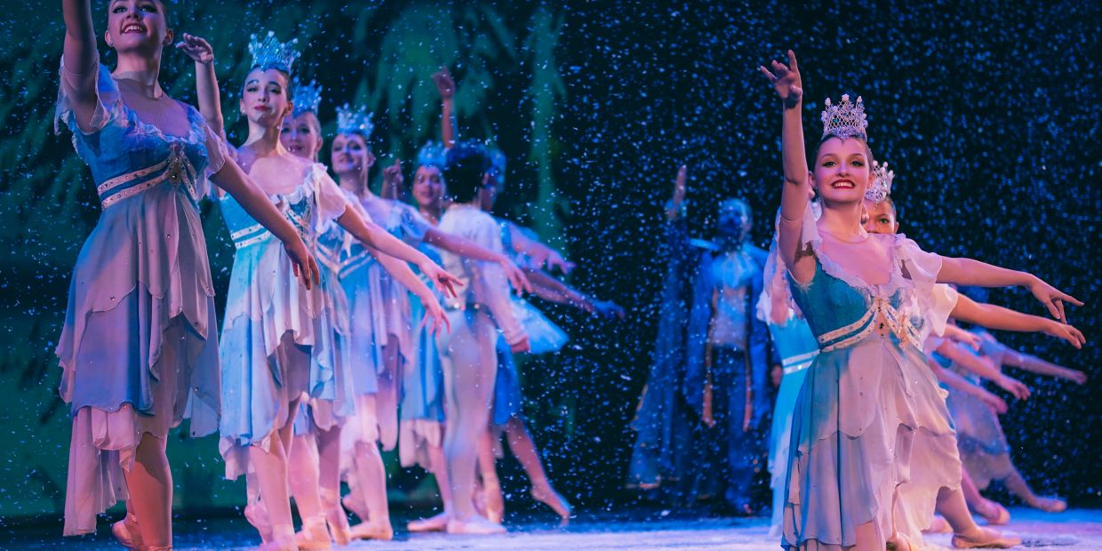 Dancers performing in a snowy-themed ballet.