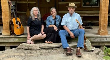 Ma Crow, Dale Farmer, Wendy Muncy of The Farmer and The Crow, log cabin front porch