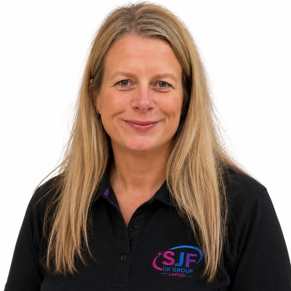 Smiling woman in a black polo shirt with SJF UK Group Limited logo.