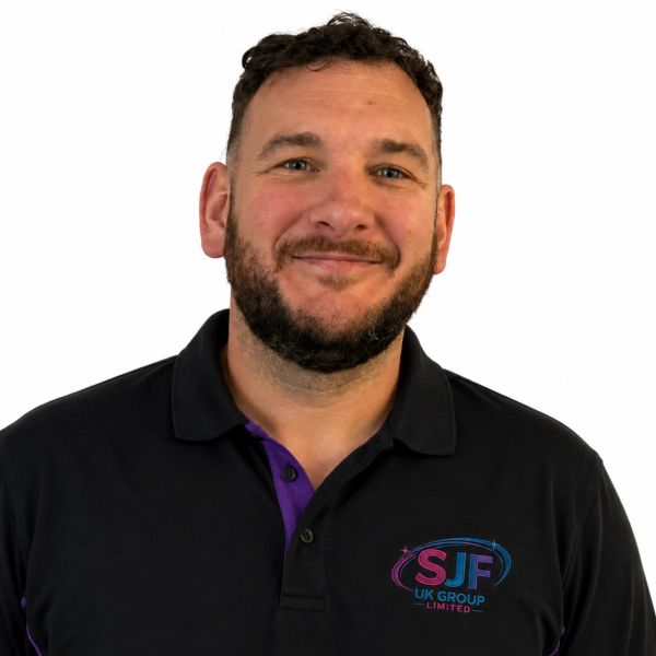 Smiling man wearing a black SJF UK Group Limited polo shirt.
