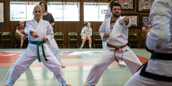 Two adults, a male and a female, demonstrating their Karate reverse punches.