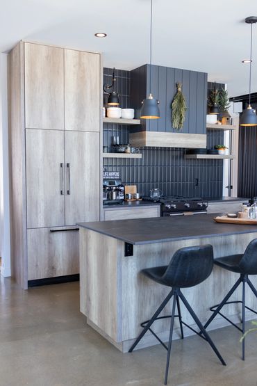 Close up of built-in kitchen appliance cabinets with oak panels covering fridge