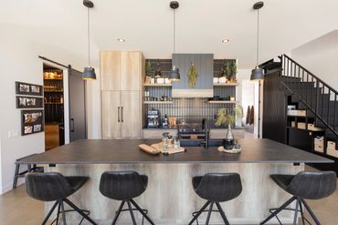 Full horizontal view of cabin kitchen with oak and black accents
