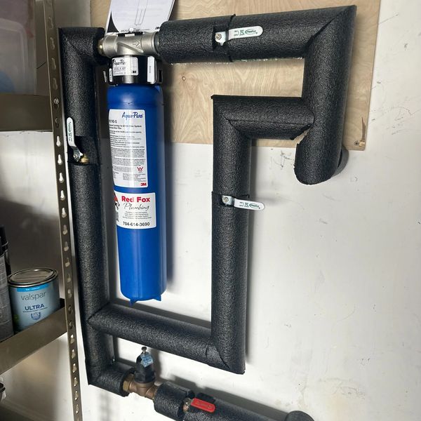 Blue water filtration system with insulated pipes.