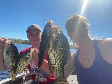 Fishermen holding crappie in the boat