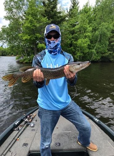 Fishermen holding a northern pike on the Chippewa Flowage