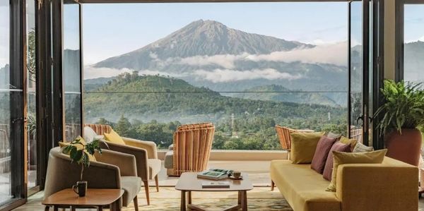 Cozy living room with a stunning mountain view through large open windows.