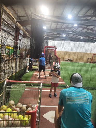 Coach Cam Lewis working with a few of our kids at a summer camp.