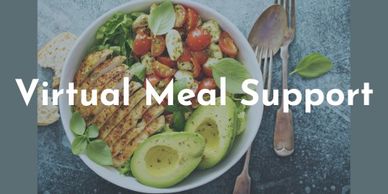 Ad for virtual meal support. A bowl of salad with chicken and avocado sitting on a table.