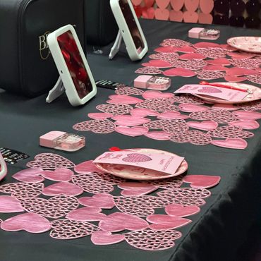 Valentine's Day decorated table with heart motifs and thank you cards.
