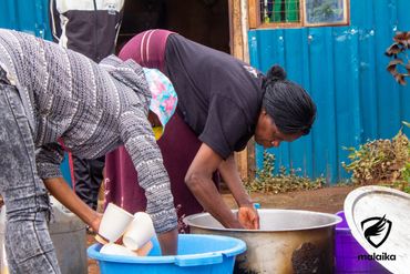 February 24th Action - Women getting mugs ready for the children