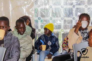 February 24th Action - kids enjoying porridge