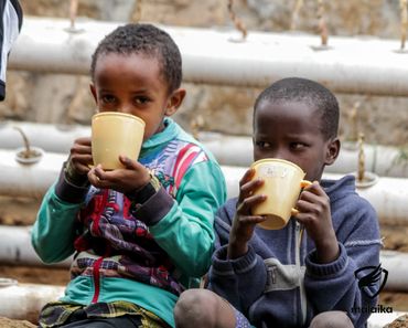 February 24th Action - two young boys drinking porridge