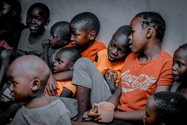 February 10th Action - Young boys sitting against the wall watching performances